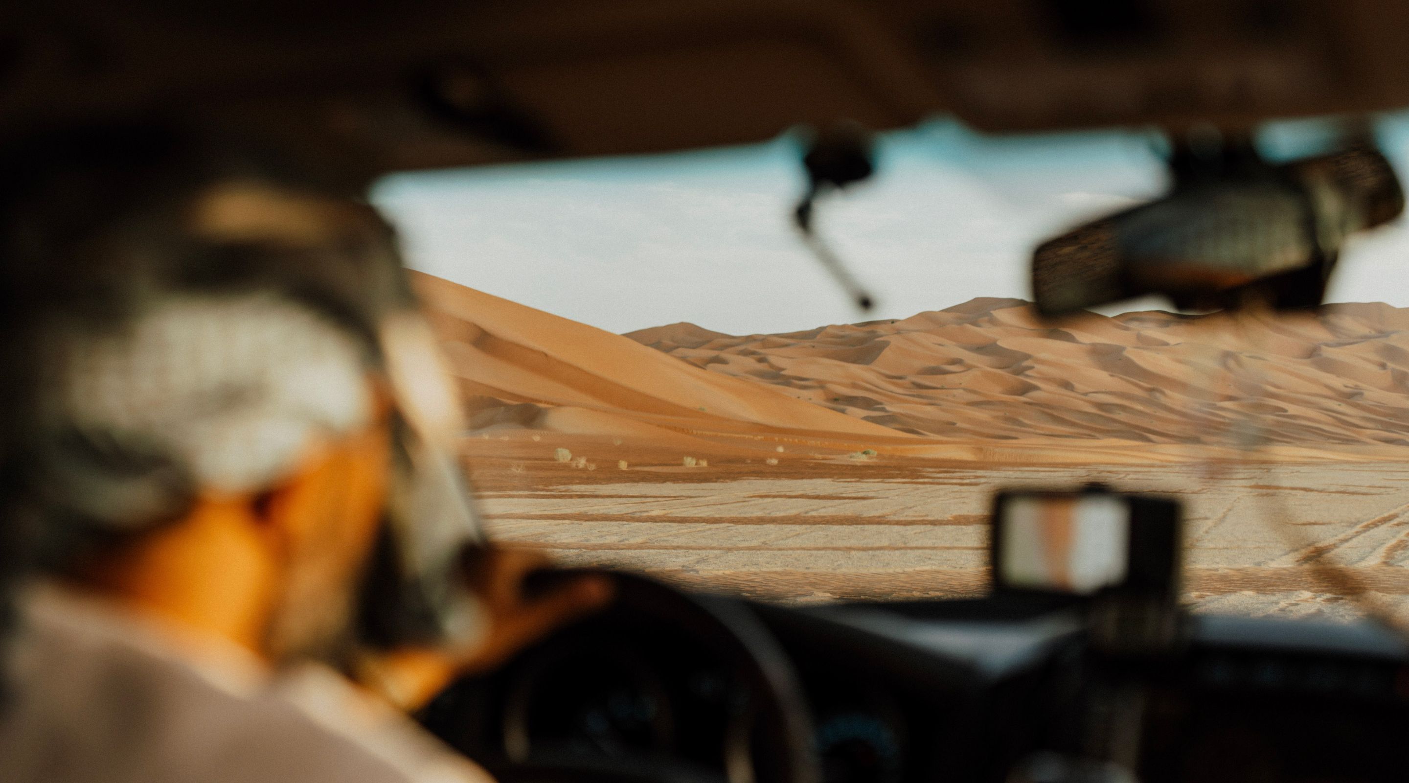 passenger view from a 4x4 vehicle driving through the desert