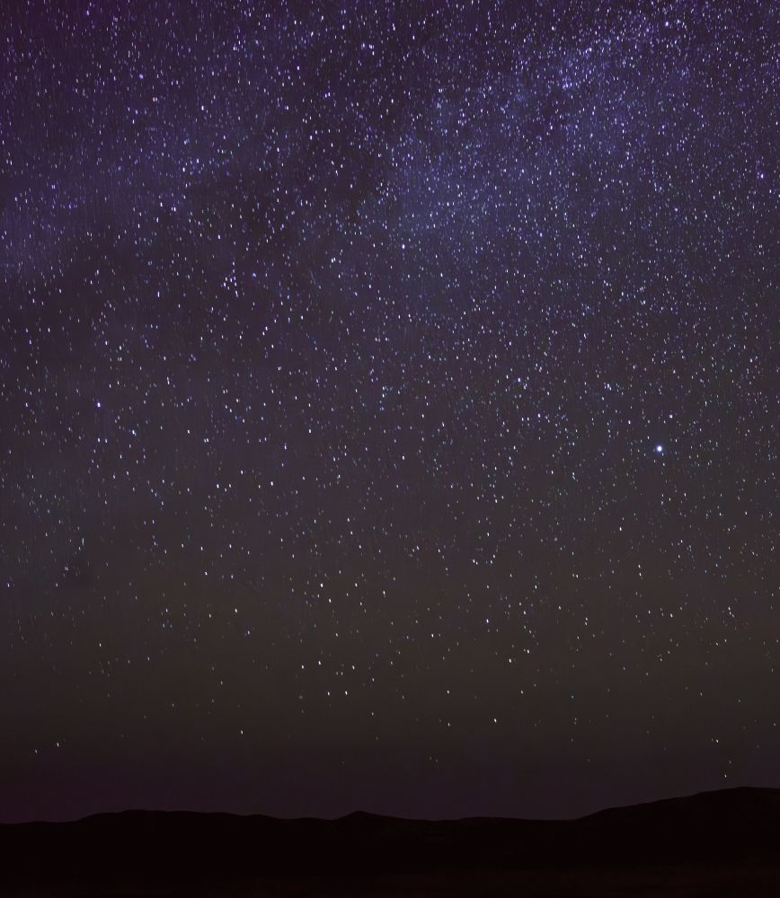 extremely dark night sky with a vast array of visible stars.